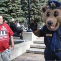 A PSAC member with CIU's Buddy the Bear at the Calgary Labour Day BBQ.