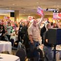 Delegates at 2014 SFL Convention show support by holding up signs.