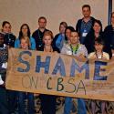 Young workers caucus holding "Shame on CBSA" banner that was made at the Regiona